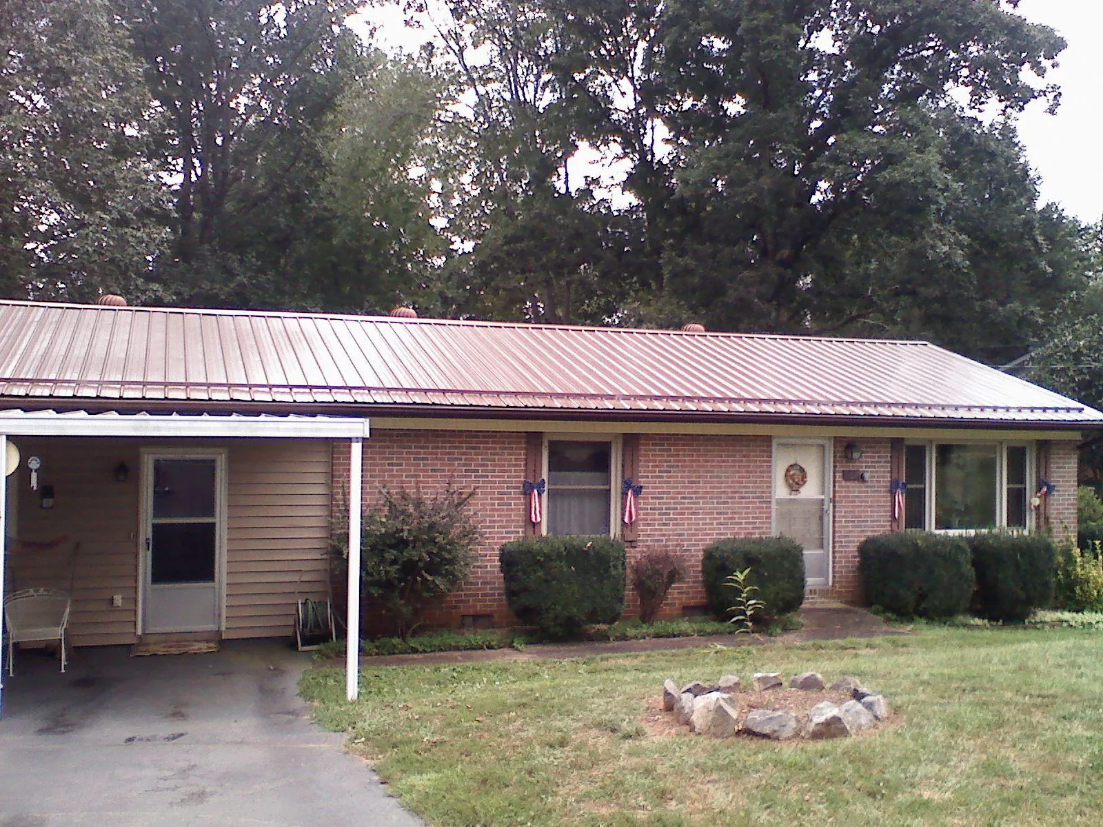 Bronze metal roof and carport on a brick ranch home — Roof Repair work by our crew in Kingsburg